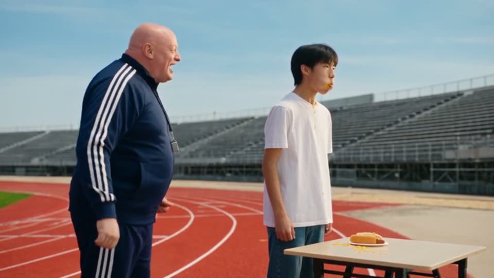 Mike and his bald coach on a red running track